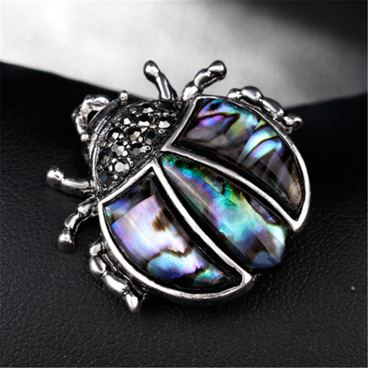 Broche Mariquita de Plata Antigua con Cristales de Siete Puntas - Accesorio Versátil Unisex