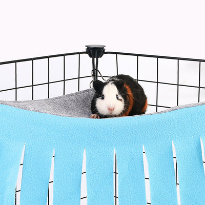 Blue and gray pet hammock with tassels hanging in a black wire cage, with a small hamster peeking out. - Image 10
