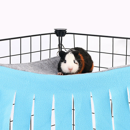 Blue and gray pet hammock with tassels hanging in a black wire cage, with a small hamster peeking out. - Image 6