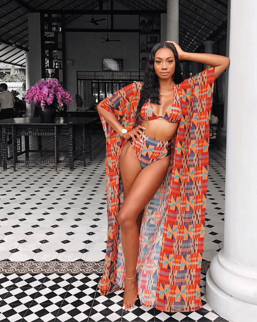 Woman wearing a red, orange, and blue geometric print three-piece swimsuit with a high-waisted bikini and long kimono cover-up. - Image 8