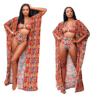 Woman wearing a red, orange, and blue geometric print three-piece swimsuit with a high-waisted bikini and long kimono cover-up. - Image 9