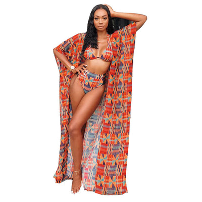 Woman wearing a red, orange, and blue geometric print three-piece swimsuit with a high-waisted bikini and long kimono cover-up. - Image 11