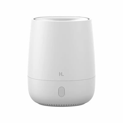 White minimalist aroma diffuser emitting mist, with a single button, on a white nightstand next to a bed. - Image 6