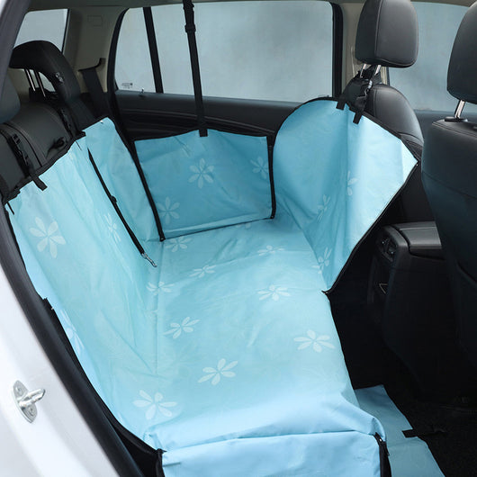 Beige pet car seat cover with a colorful dog pattern, installed in the rear of a car to protect seats. - Image 7