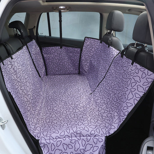 Beige pet car seat cover with a colorful dog pattern, installed in the rear of a car to protect seats. - Image 9