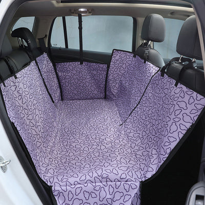 Beige pet car seat cover with a colorful dog pattern, installed in the rear of a car to protect seats. - Image 5