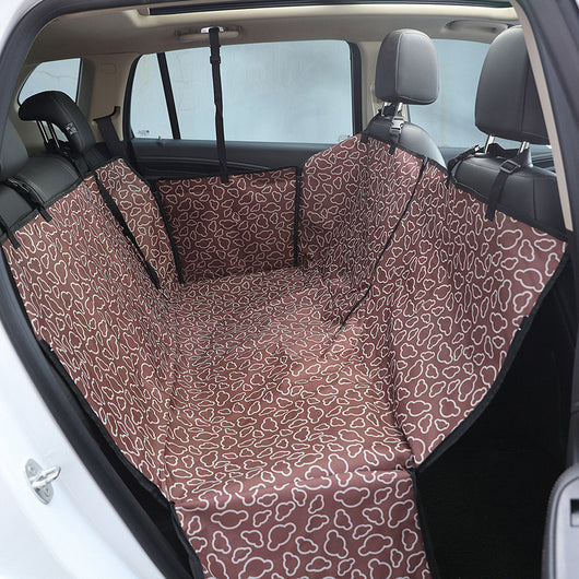 Beige pet car seat cover with a colorful dog pattern, installed in the rear of a car to protect seats. - Image 4