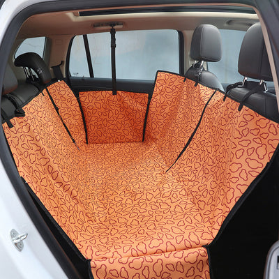 Beige pet car seat cover with a colorful dog pattern, installed in the rear of a car to protect seats. - Image 3