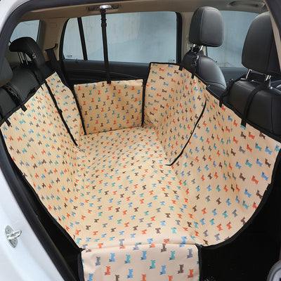 Beige pet car seat cover with a colorful dog pattern, installed in the rear of a car to protect seats. - Image 2