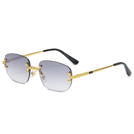 Rimless square sunglasses with gradient orange-red lenses and gold-tone metal temples, featuring textured details.