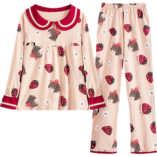 Young girl wearing a light pink two-piece pajama set with red Peter Pan collar and strawberry print. - Image 6
