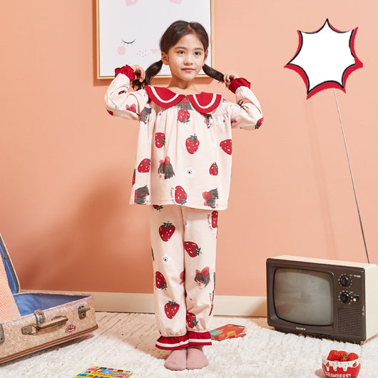 Young girl wearing a light pink two-piece pajama set with red Peter Pan collar and strawberry print. - Image 7