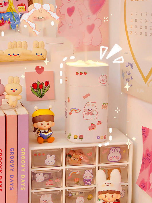 White desktop humidifier with a soft glow, decorated with cute cartoon animal and fruit stickers, shown with a USB cable and a sheet of additional stickers. - Image 6