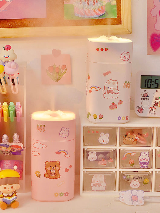 White desktop humidifier with a soft glow, decorated with cute cartoon animal and fruit stickers, shown with a USB cable and a sheet of additional stickers. - Image 3