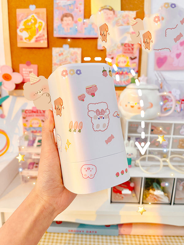 White desktop humidifier with a soft glow, decorated with cute cartoon animal and fruit stickers, shown with a USB cable and a sheet of additional stickers.