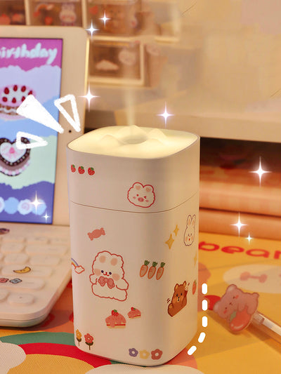 White desktop humidifier with a soft glow, decorated with cute cartoon animal and fruit stickers, shown with a USB cable and a sheet of additional stickers. - Image 2