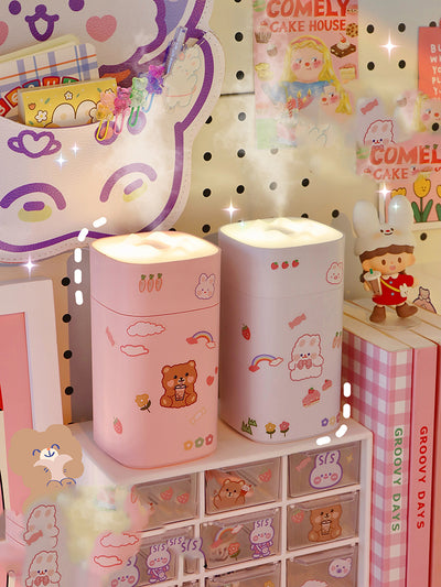 White desktop humidifier with a soft glow, decorated with cute cartoon animal and fruit stickers, shown with a USB cable and a sheet of additional stickers. - Image 7