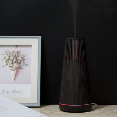Dark wood grain electric essential oil aroma diffuser with a ribbed conical shape and LED light ring. - Image 9