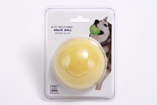 Pink rubber pet bouncy ball with an embossed skull and crossbones design, held in a hand. - Image 11