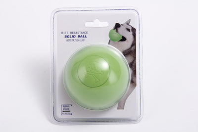 Pink rubber pet bouncy ball with an embossed skull and crossbones design, held in a hand. - Image 8