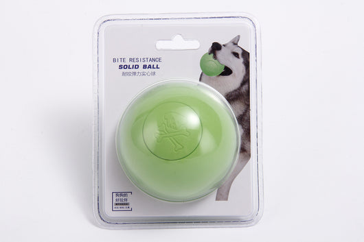 Pink rubber pet bouncy ball with an embossed skull and crossbones design, held in a hand. - Image 8