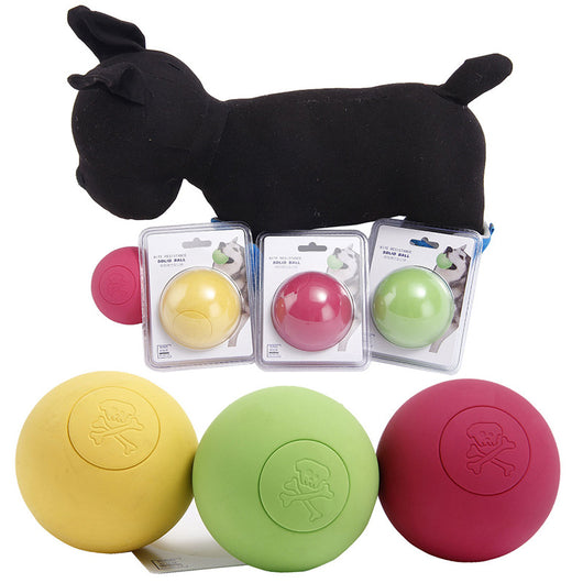 Pink rubber pet bouncy ball with an embossed skull and crossbones design, held in a hand. - Image 10