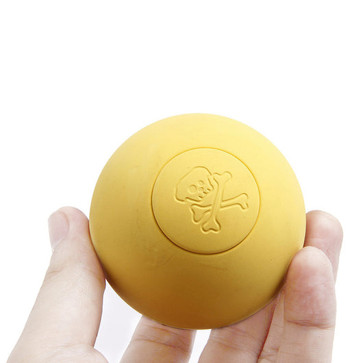 Pink rubber pet bouncy ball with an embossed skull and crossbones design, held in a hand. - Image 13