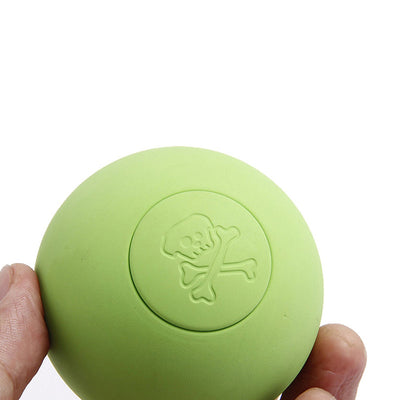 Pink rubber pet bouncy ball with an embossed skull and crossbones design, held in a hand. - Image 14
