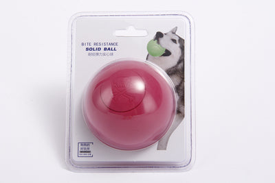 Pink rubber pet bouncy ball with an embossed skull and crossbones design, held in a hand. - Image 5