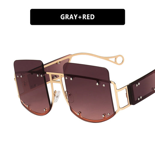 Red oversized rimless sunglasses with a unique geometric design and gold-tone metal temples. - Image 6