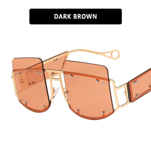 Red oversized rimless sunglasses with a unique geometric design and gold-tone metal temples. - Image 8