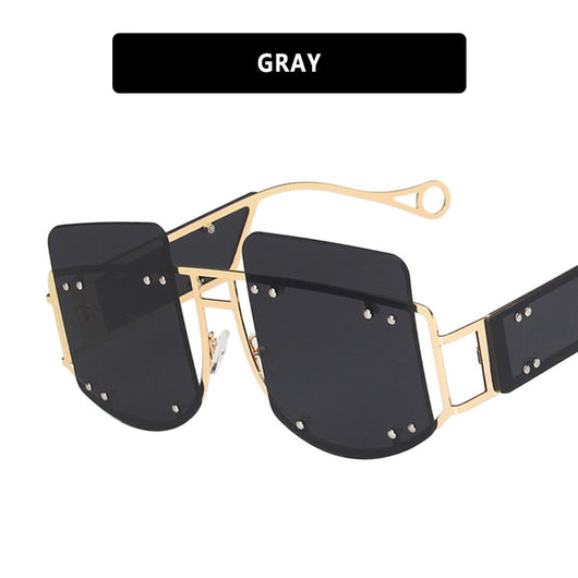 Red oversized rimless sunglasses with a unique geometric design and gold-tone metal temples. - Image 5