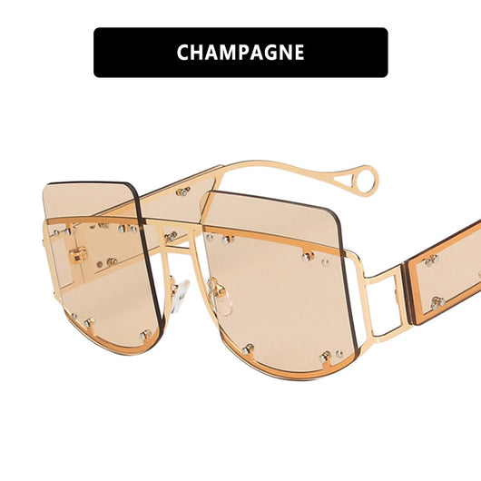 Red oversized rimless sunglasses with a unique geometric design and gold-tone metal temples. - Image 7