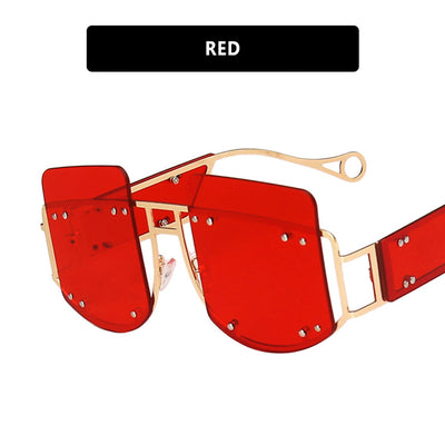 Red oversized rimless sunglasses with a unique geometric design and gold-tone metal temples. - Image 9