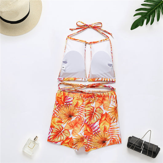 Two-piece bikini with green tropical leaf print, halter top, and high-waisted boxer shorts on a white background. - Image 23