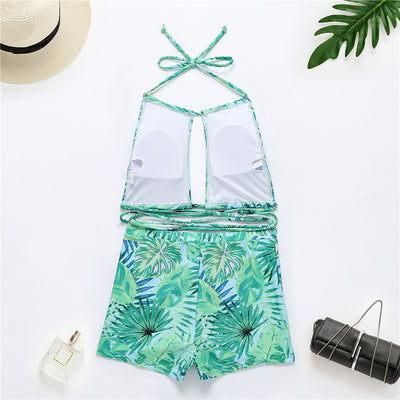 Two-piece bikini with green tropical leaf print, halter top, and high-waisted boxer shorts on a white background. - Image 24