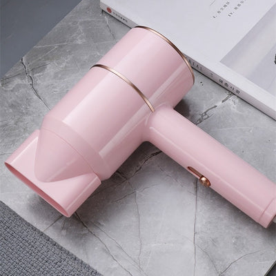 Mini negative ion hair dryer with a pink to purple gradient finish and silver accents, featuring a compact T-shape. - Image 23