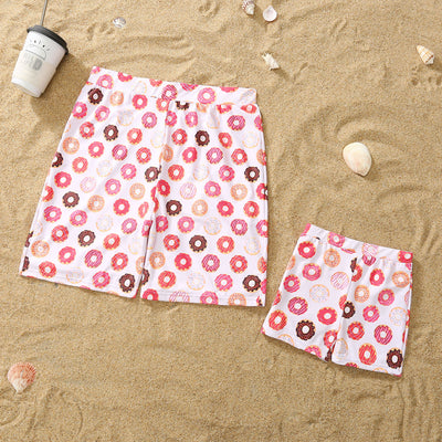 Family matching donut print swimsuits including men's shorts, boy's trunks, women's off-shoulder bikini, and girl's one-piece. - Image 14