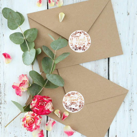 Roll of white paper 'Thank You' stickers with rose gold foil text and a delicate floral wreath design. - Image 2