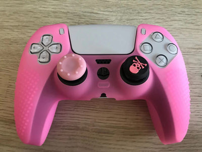 Pink silicone protective cover for PS5 gamepad with textured grips and skull and crossbones thumbstick cap. - Image 10