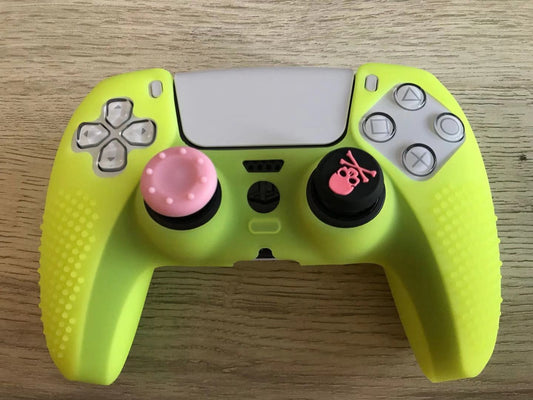 Pink silicone protective cover for PS5 gamepad with textured grips and skull and crossbones thumbstick cap. - Image 2