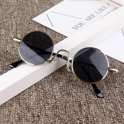 Retro round sunglasses with gold-colored frames and yellow tinted lenses, displayed on a textured surface. - Image 11