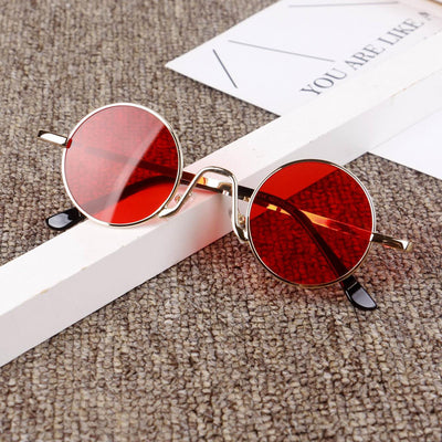 Retro round sunglasses with gold-colored frames and yellow tinted lenses, displayed on a textured surface. - Image 6