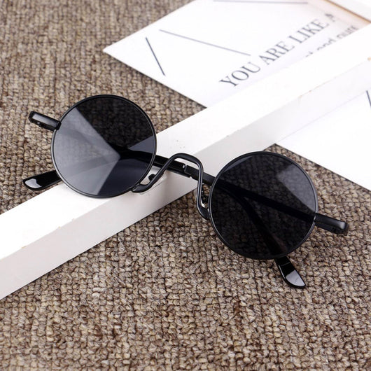 Retro round sunglasses with gold-colored frames and yellow tinted lenses, displayed on a textured surface. - Image 4