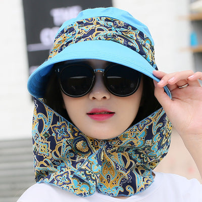 Woman wearing a light yellow wide-brim sun hat with a colorful paisley neck flap and dark sunglasses. - Image 13