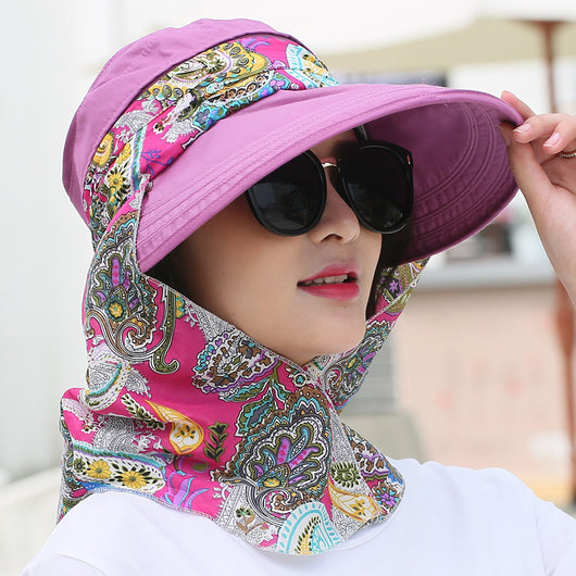 Woman wearing a light yellow wide-brim sun hat with a colorful paisley neck flap and dark sunglasses. - Image 20