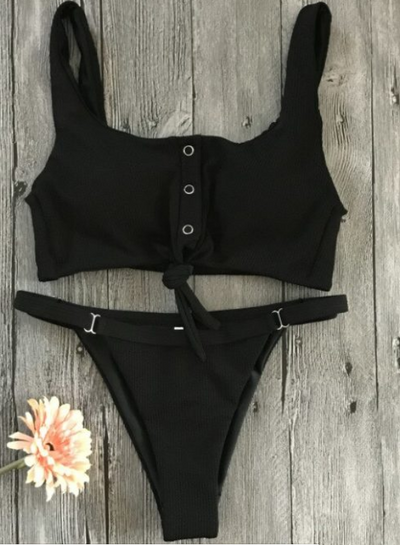 Red two-piece bikini with a square neck, button-front tie top, and high-cut bottoms on a wooden background.