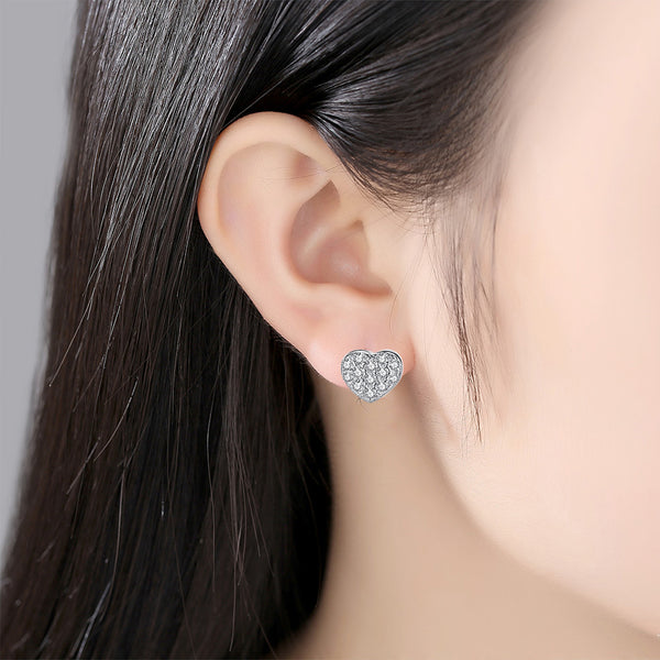 Sterling silver heart-shaped stud earrings with pavé clear zircons, featuring butterfly backings.