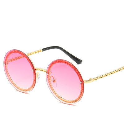 Frameless round sunglasses with pink gradient lenses and gold-tone chain detail on temples and lens edges. - Image 3