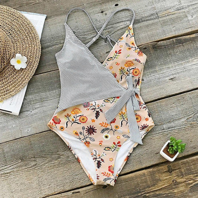 Maternity one-piece swimsuit with a wrap V-neck, featuring a mix of black and white stripes and a peach floral print. - Image 11